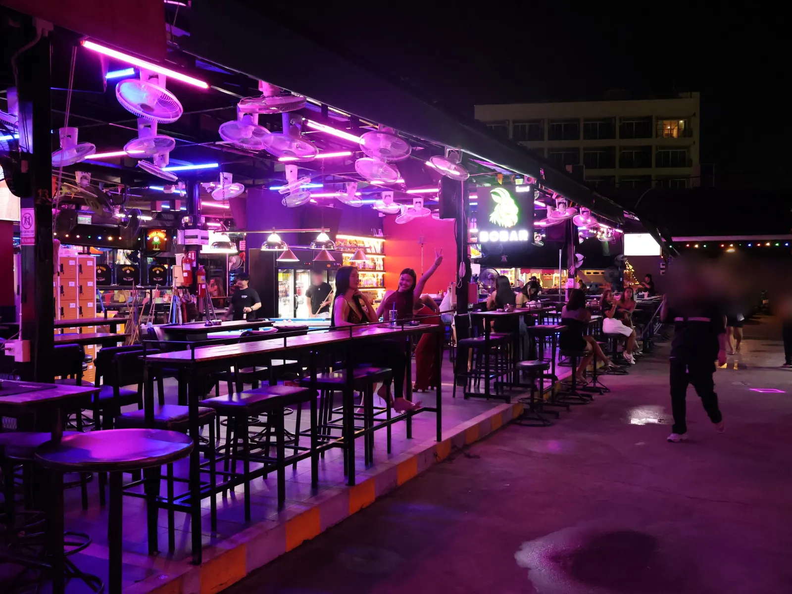 BoBar seen from the Myth Night walkway at night, with fans and neon lights
