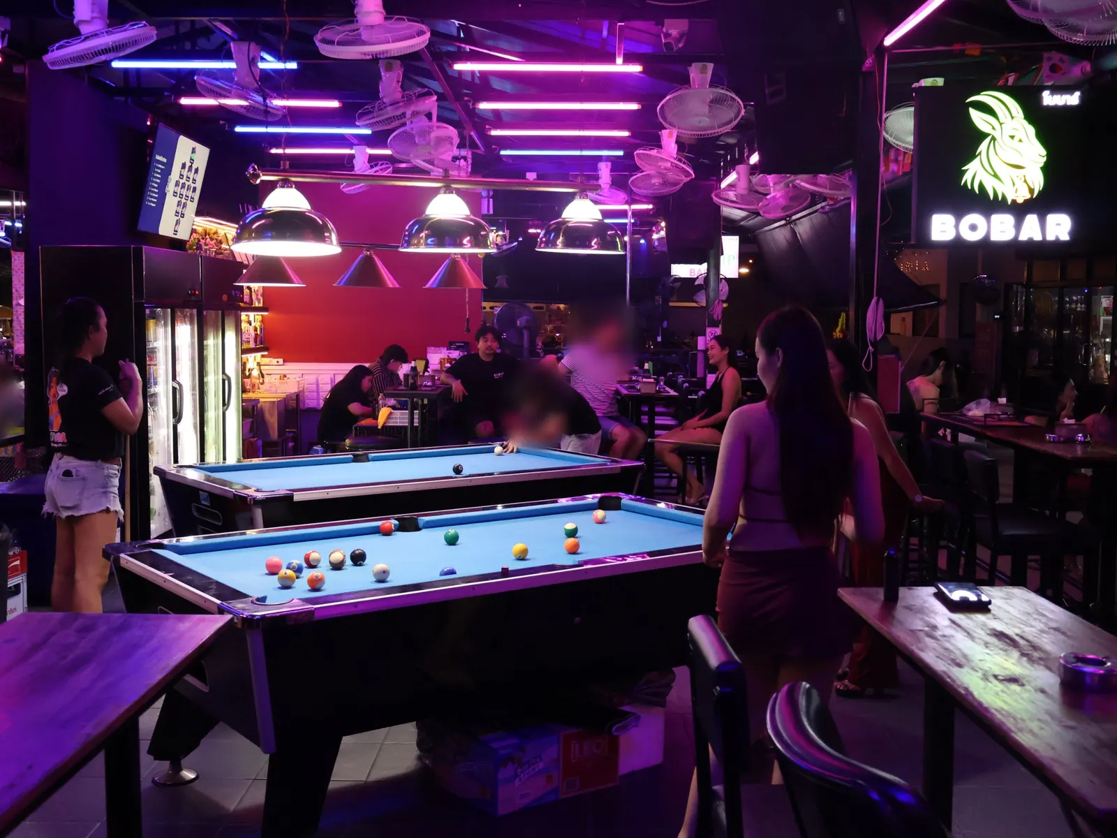 Guests playing pool on a busy night